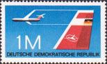 Самолет в полете. Государственный флаг ГДР и эмблема государственной авиакомпании «Интерфлюг»