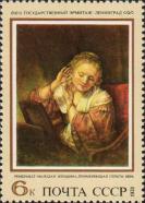 Рембрандт Харменс ван Рейн (1606–1669). «Молодая женщина, примеряющая серьги»