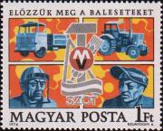 Автомобиль, трактор, рабочий с защитной маской на лице и сварщик; эмблема венгерского союза профсоюзов (ВСП) на фоне сцепленных шестерен. Текст: «Предупредим несчастные случаи»